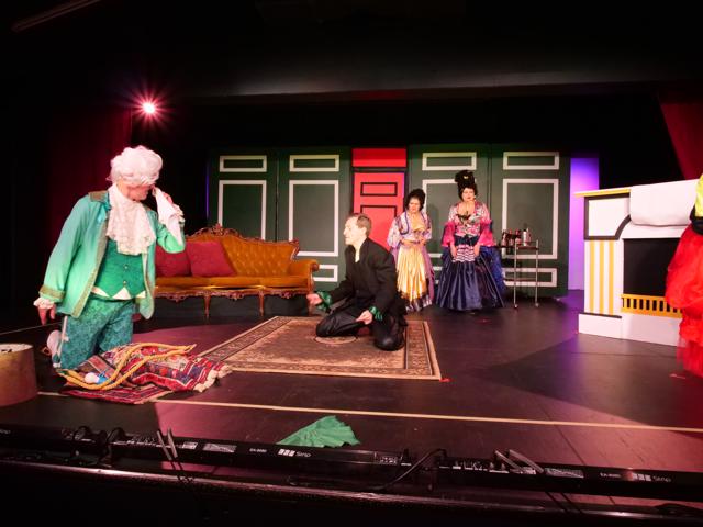 Flummoxed actors performing on stage